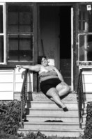 A sun worshipper takes to the stoop and enjoys rays and solitude.